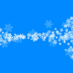Christmas snow background with scattered snowflakes falling in winter