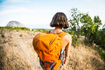 A woman is traveling with a backpack.