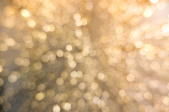 Abstract yellow bokeh circles for Christmas background. Royalty high-quality free stock photo of Christmas light overlay background. Holiday glowing backdrop. Defocused background with blinking stars
