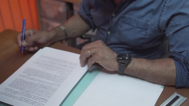 High-angle shot on a teacher correcting an essay