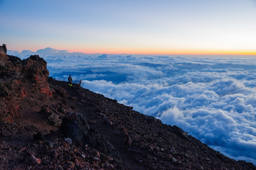 A Lonely Man Watching the Sunrise At the top of the Mt. Fuji in Japan