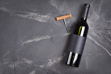 Flat lay of lying wine bottle with black empty label for tasting and copy space