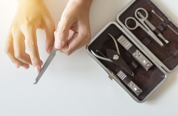 Woman cutting nails with nail clipper,Female using tweezers,Rasp