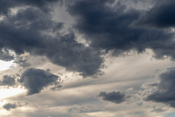 Grey clouds in front of an orange sky 