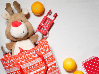 Christmas toy reindeer as a gift with copy space on a white background