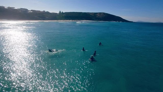 4k Drone footage of surfers at a beautiful Australian coastal beach landscape.