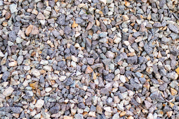 Surface of grey gravel lying on the ground
