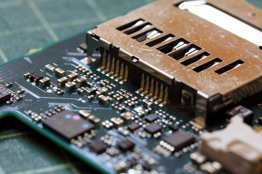 Electronics background technology close up of the green kit circuit board. Application Specific Integrated Circuit.