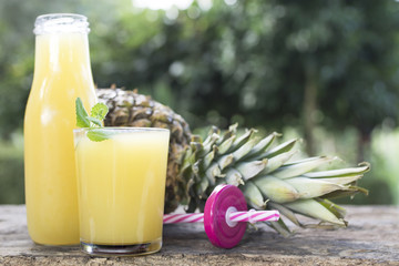 pineapple juice on rustic wood, concept of diet and health