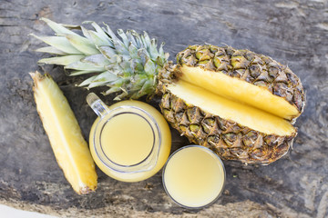 pitcher of pineapple juice on rustic wood, diet and healthy drink concept