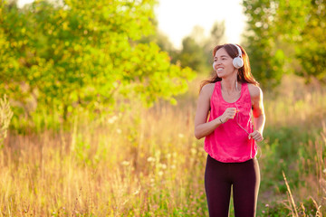 Young smiling woman doing sporty exercises outdoors