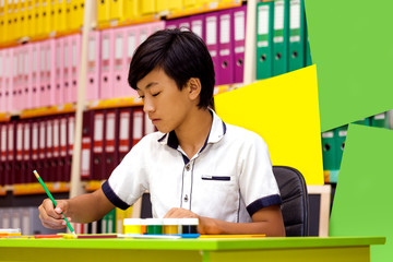 Portrait classman schoolboy study sitting books asian boy lesson school board briefcase backpack pencil globe yellow green