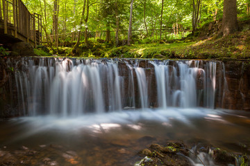 Waterfalls of Ieriku nature park at old watermill in the forest. It's a part of Gauja National park, Latvia.