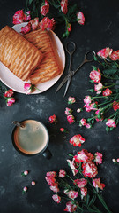 Pink flowers, puff pastries and coffee on a dark background, Bush roses, Blog style, Flatlay, Floral, Postcard