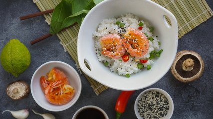 Asian food on a dark background, Wok rice with shrimps and mushrooms, During preparation