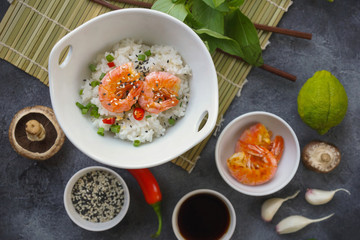 Asian food on a dark background, Wok rice with shrimps and mushrooms, During preparation