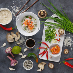 Asian food on a dark background, Wok rice with shrimps and mushrooms, During preparation