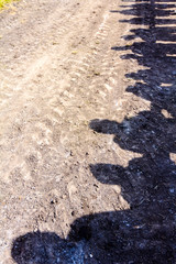 Silhouette, shadows of audience on dry and dusty ground
