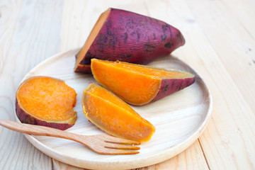 Sweet potato steamed in wood dish on wooden table