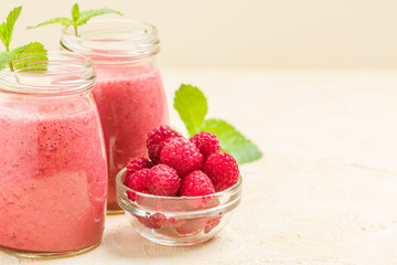 Raspberry smoothie close up photography with fresh summer blended cocktail and ripe berries.