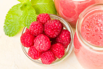 Raspberry smoothie close up photography with fresh summer blended cocktail and ripe berries.