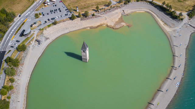 Curon, Italy. Drone aerial view of the old bell tower of the village rising out of the waters lake of Resia