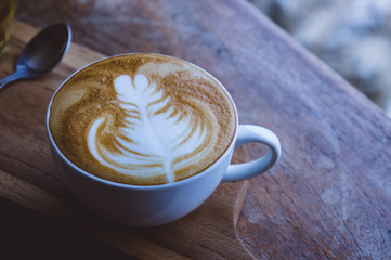 coffee hot drink cappucino latte art on wood vintage table , coffee time on wood background cafe