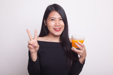 Young Asian woman show victory sign drink orange juice.