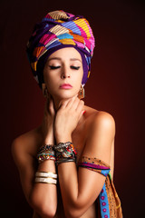Fototapeta na wymiar Studio portrait of caucasian young woman wearing colorful scarves. Ethnic fashion concept.