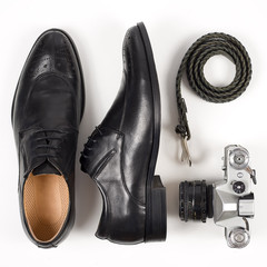 Close up of modern man accessories. bow tie, leather shoes, belt on white background.
