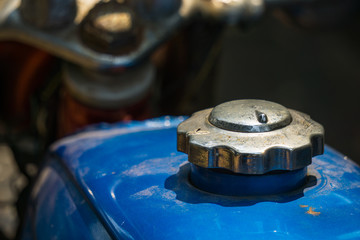 Blue fuel tank and silver cover of vintage Japanese motorcycle