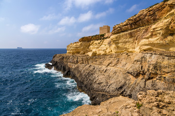 Fototapeta na wymiar Wied Iz-Zurrieq, Malta. A picturesque sea view with an old watch tower (1638)