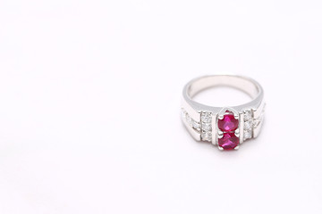 Pink gem stone on diamond ring