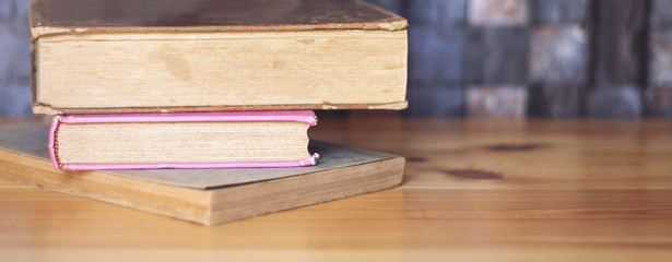     Work place table with stacks of real books on it as banner 