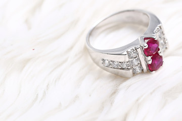 Pink gem stone on diamond ring