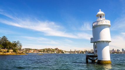 Fototapeta na wymiar Shark Island Light, an active pile lighthouse located just north of Shark Island in Sydney Harbour, New South Wales, Australia.