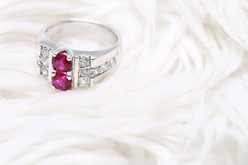 Pink gem stone on diamond ring