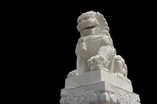 White marble Chinese guardian lion sculpture on black background with clipping path.