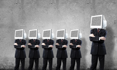 Businessmen with monitors instead of head.