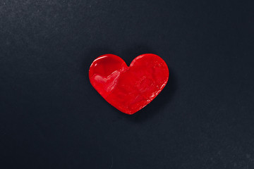 red heart shape ice cream on dark or black textured paper background