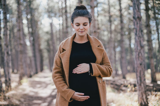 Young Beautiful Stylish Pregnant Woman Posing In Autumn Park