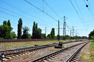 Fototapeta na wymiar Railway tracks in Kharkiv city, blue sky, bright summer day
