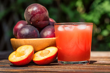 Fresh plum smoothie with plums close