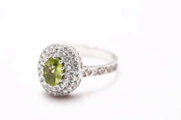 green gem stone on diamond ring