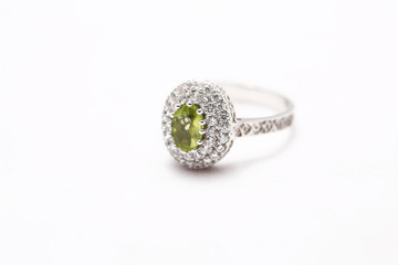 green gem stone on diamond ring