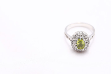 green gem stone on diamond ring