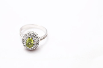 green gem stone on diamond ring