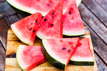 Slices of fresh watermelon on wooden board