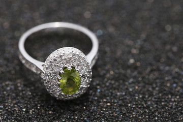 Fototapeta na wymiar green gem stone on diamond ring