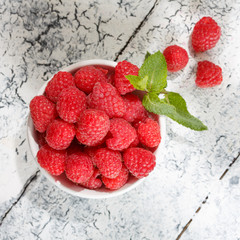 Fresh raspberries in a bowl, top view.